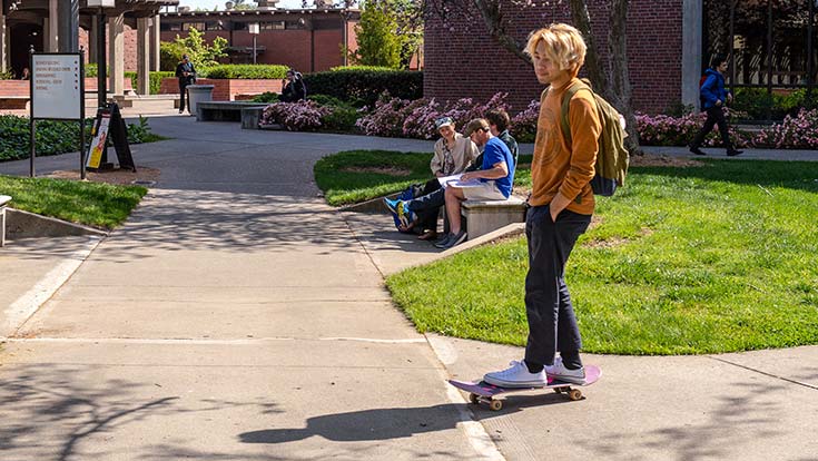 Image of a student with a skateboard